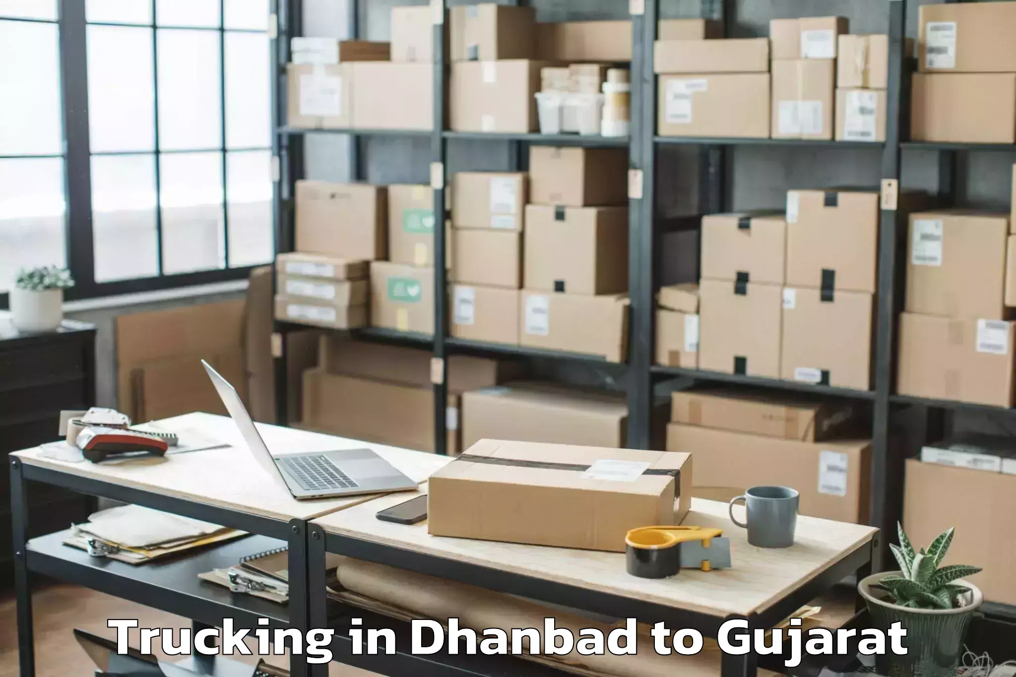 Book Dhanbad to Gussar Trucking